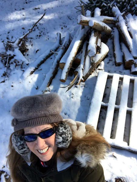 Karen Duquette and snow-covered firewood